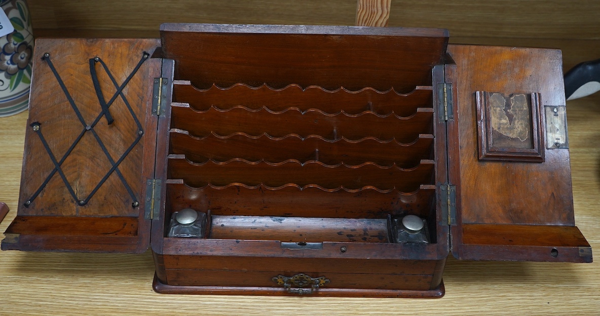 A Victorian burr walnut stationery rack, with two glass inkwells and partial label to the interior, with key, 37cm wide. Condition - fair